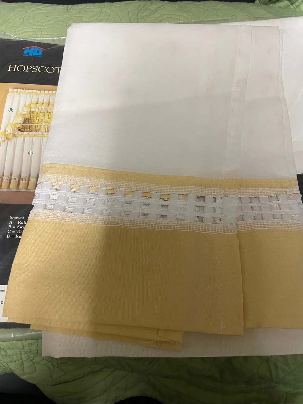 Hopscotch six pairs, a yellow and white café style curtains.